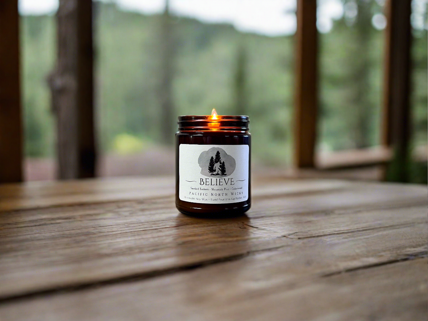 Handmade Bigfoot Gift Candle in Cabin setting with notes of forest pine, cedarwood, and campfire scents made to evoke the spirit of the PNW