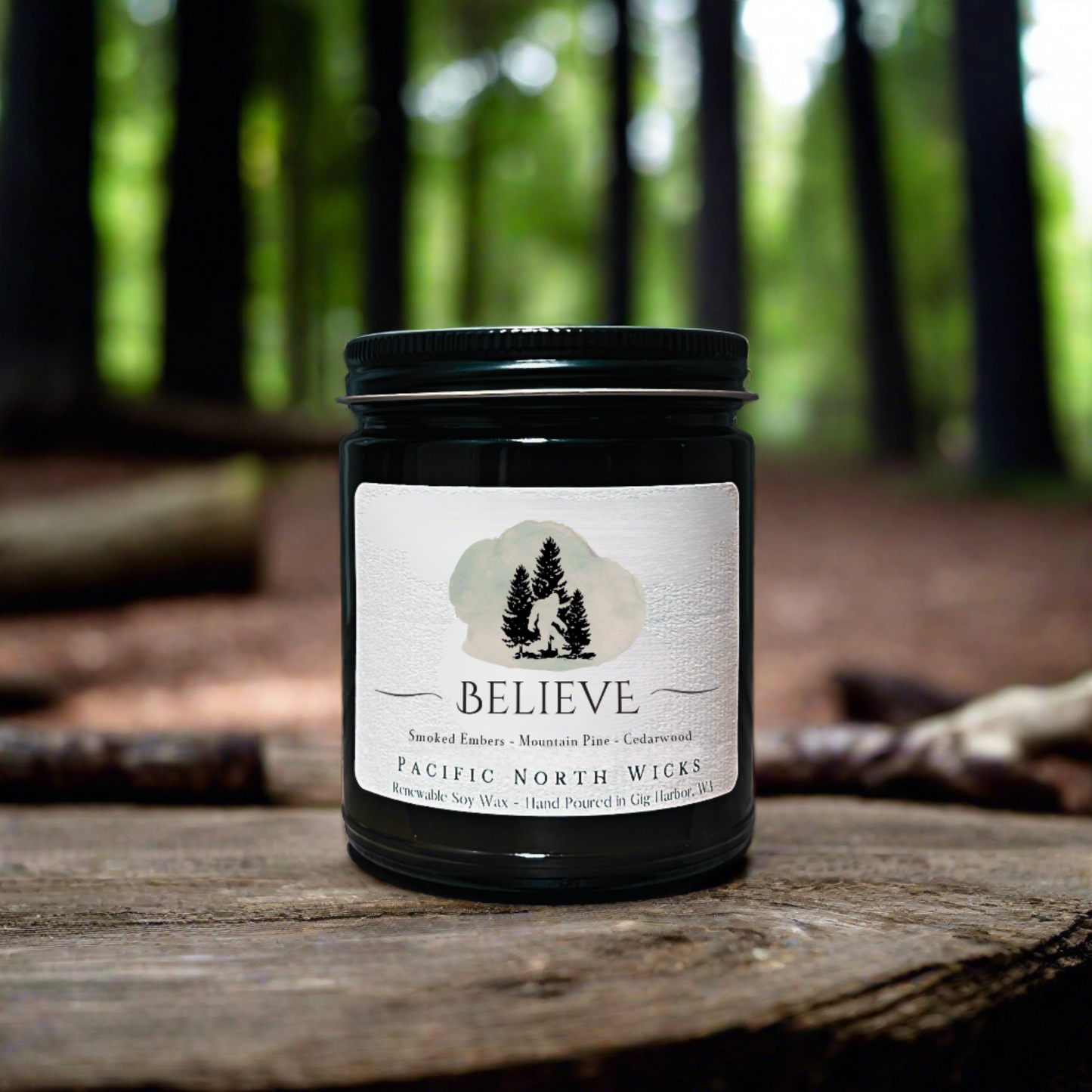 Sasquatch Gift Candle in woodsy setting in Pacific Northwest with forest trees in background