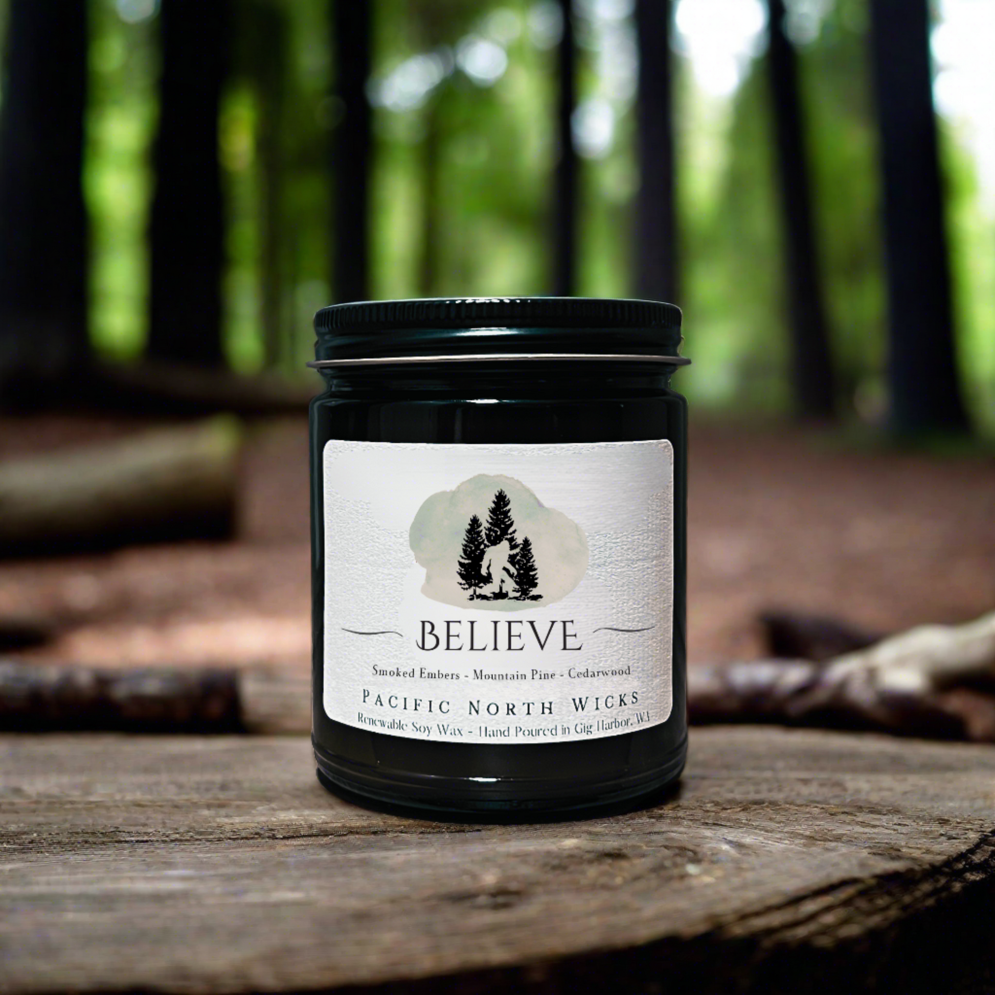 Sasquatch Gift Candle in woodsy setting in Pacific Northwest with forest trees in background