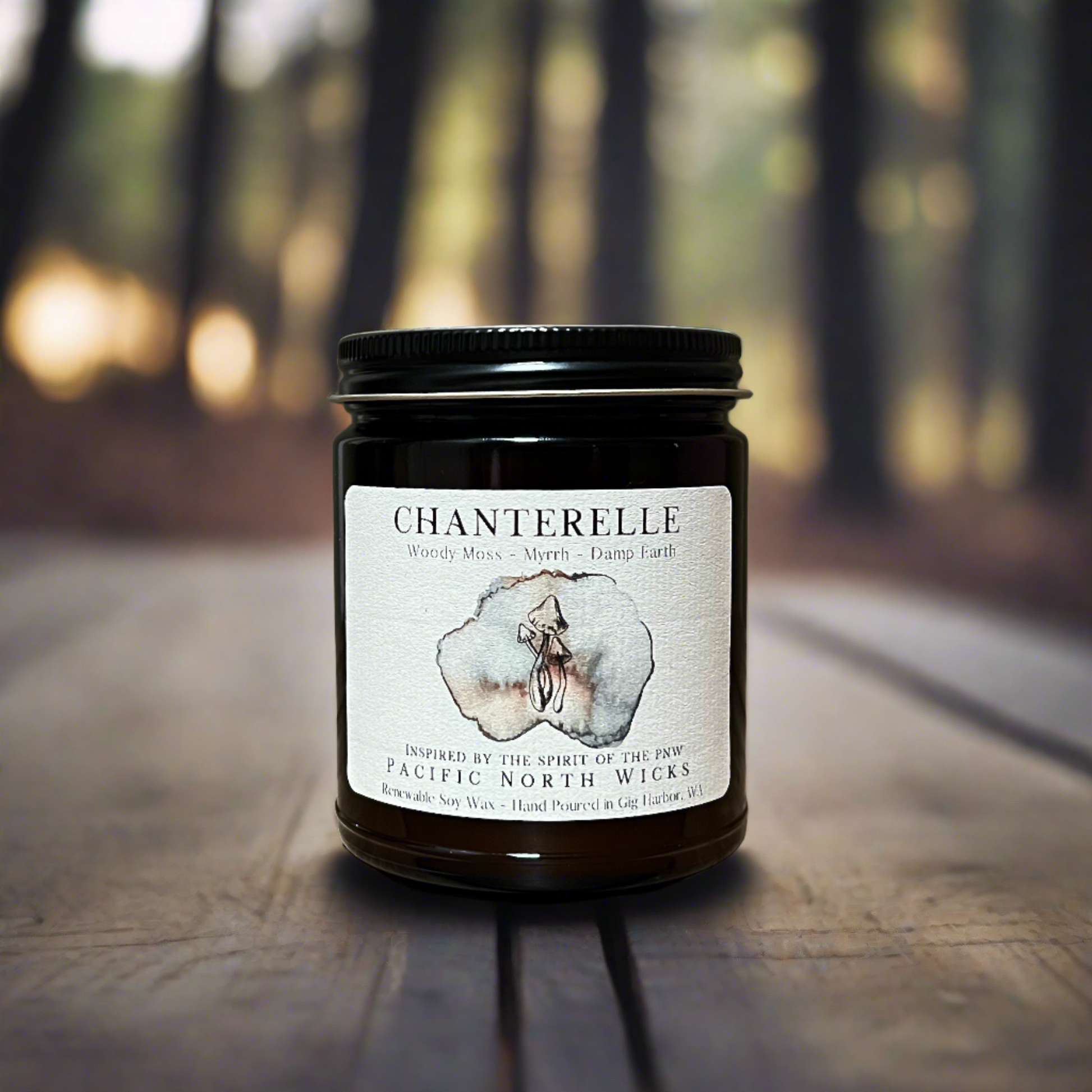 Chanterelle Candle in woodsy setting at sunset with filtered light coming through fir trees.