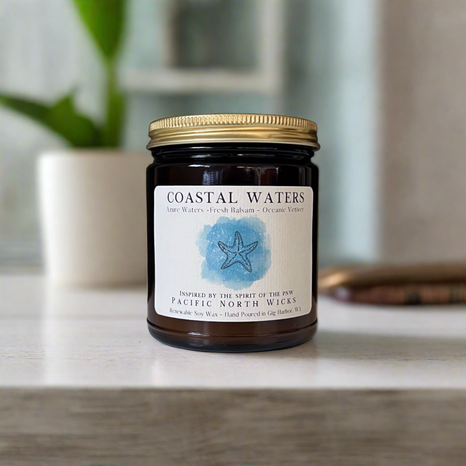 Beach Candle with bohemian inspired label in dark amber jar with gold lid set in Coastal Home with minimalist decor.