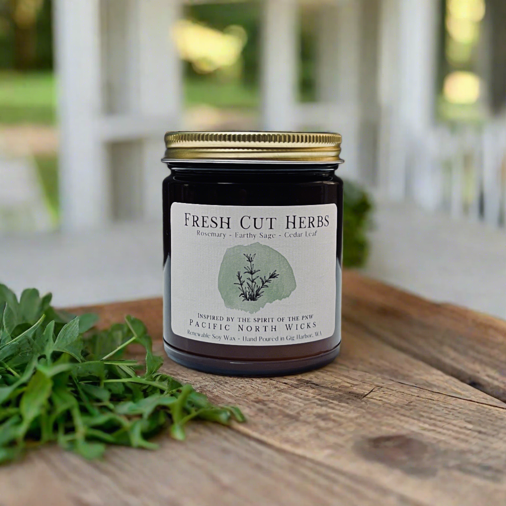 Amber jar herbal candle with gold lid in outdoor setting on farmhouse porch.