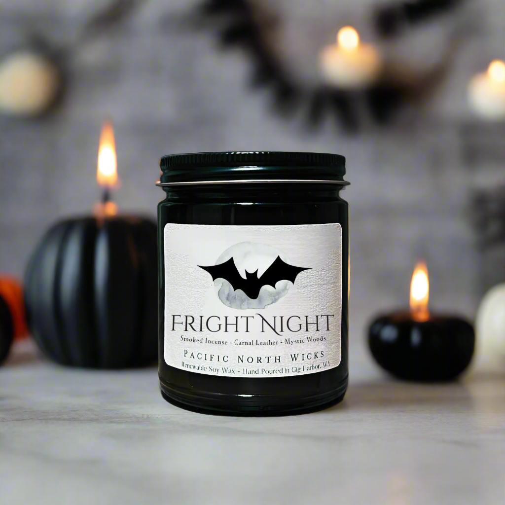Fright Night Candle with scent notes of smoked incense, carnal leather, and mystic woods.  Halloween decor in background.