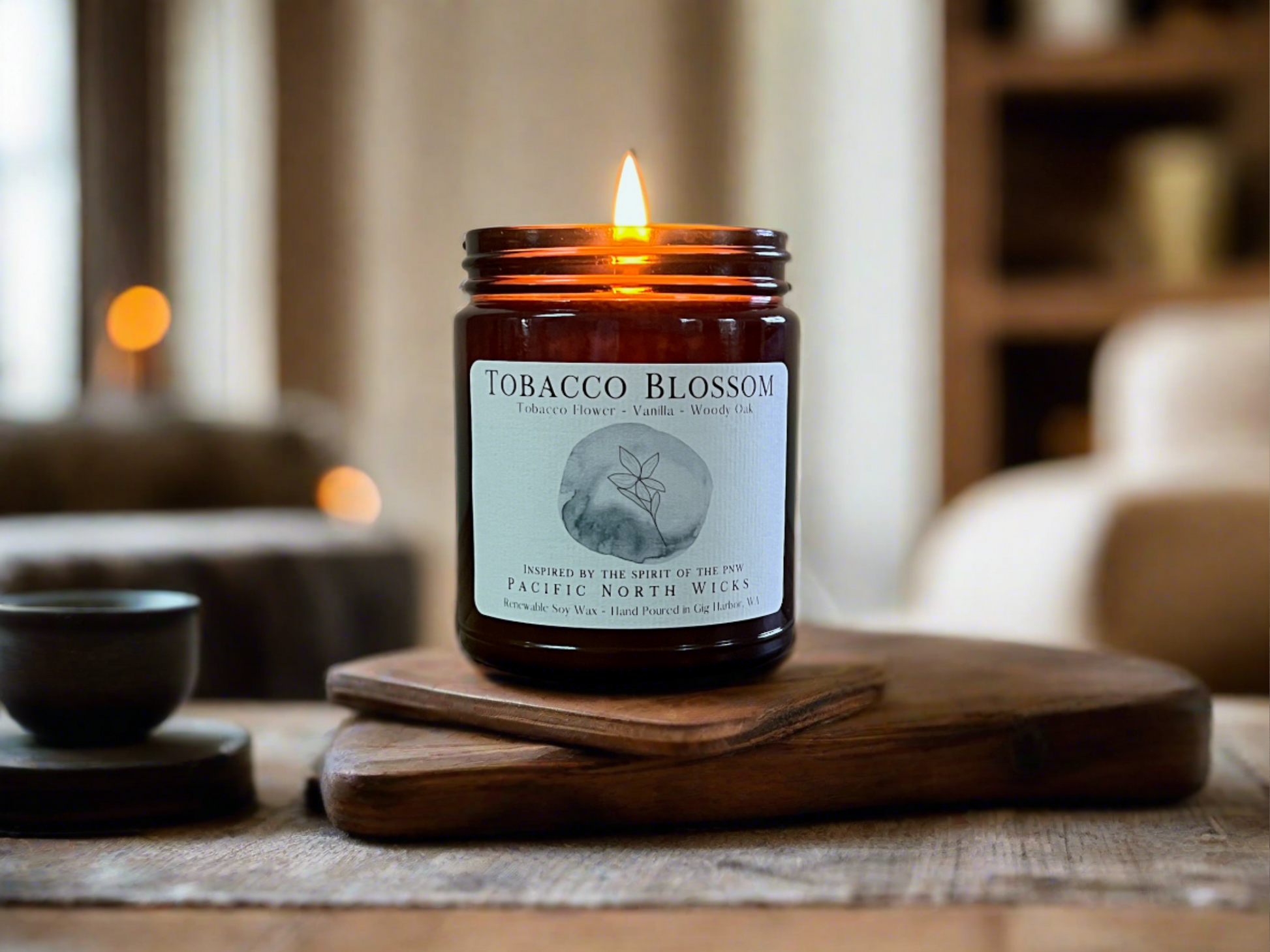 Masculine candle made with natural soy wax called Tobacco Blossom lit in modern masculine living room.