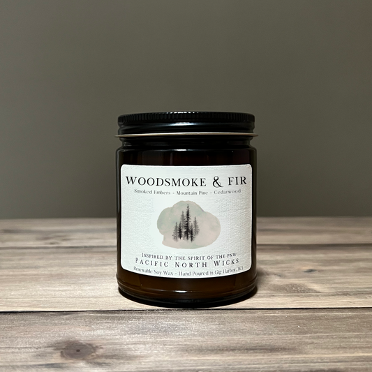 Woodsmoke & Fir Candle on a wooden slab with tan background