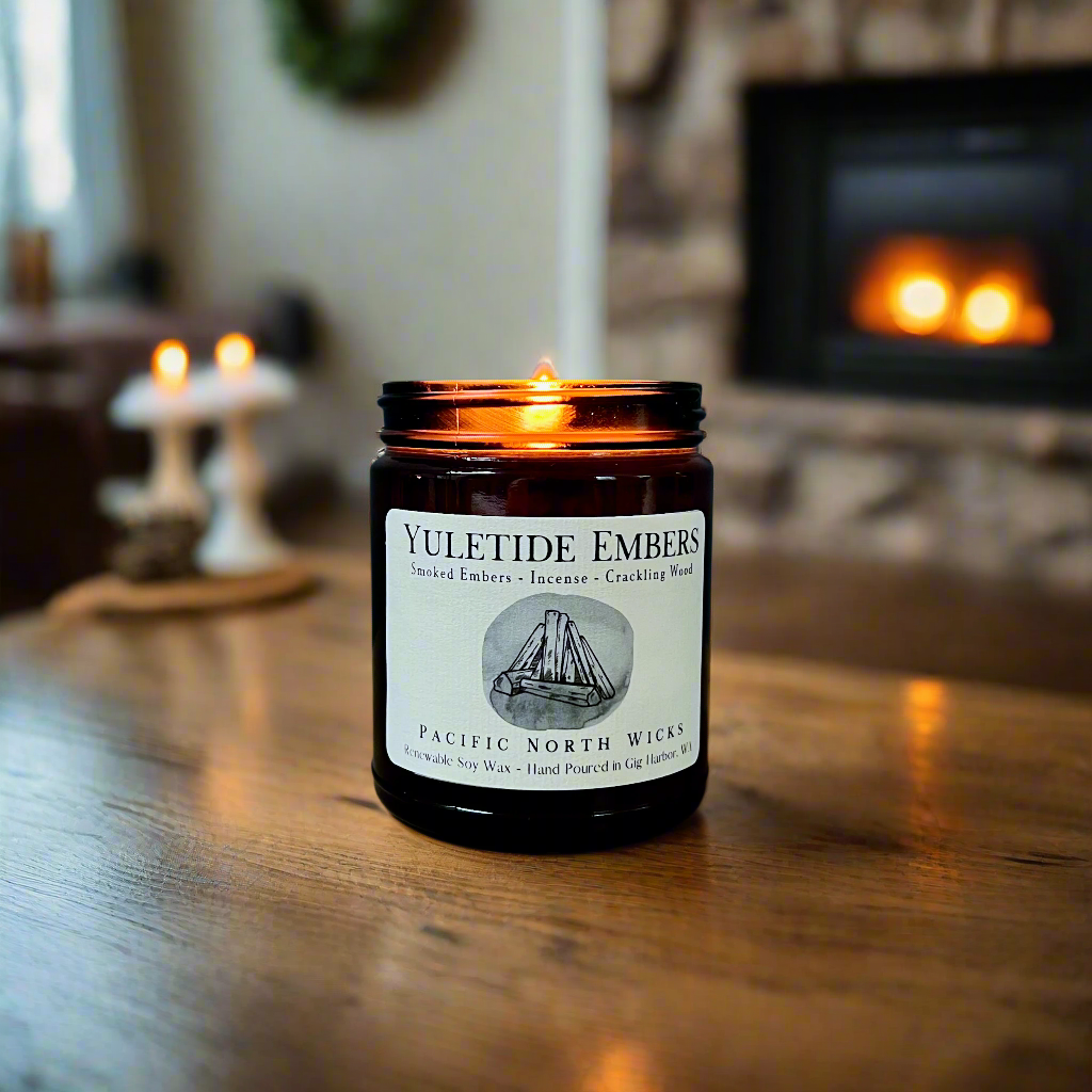 Fireside scented candle with Holiday label in cozy setting by the fire.
