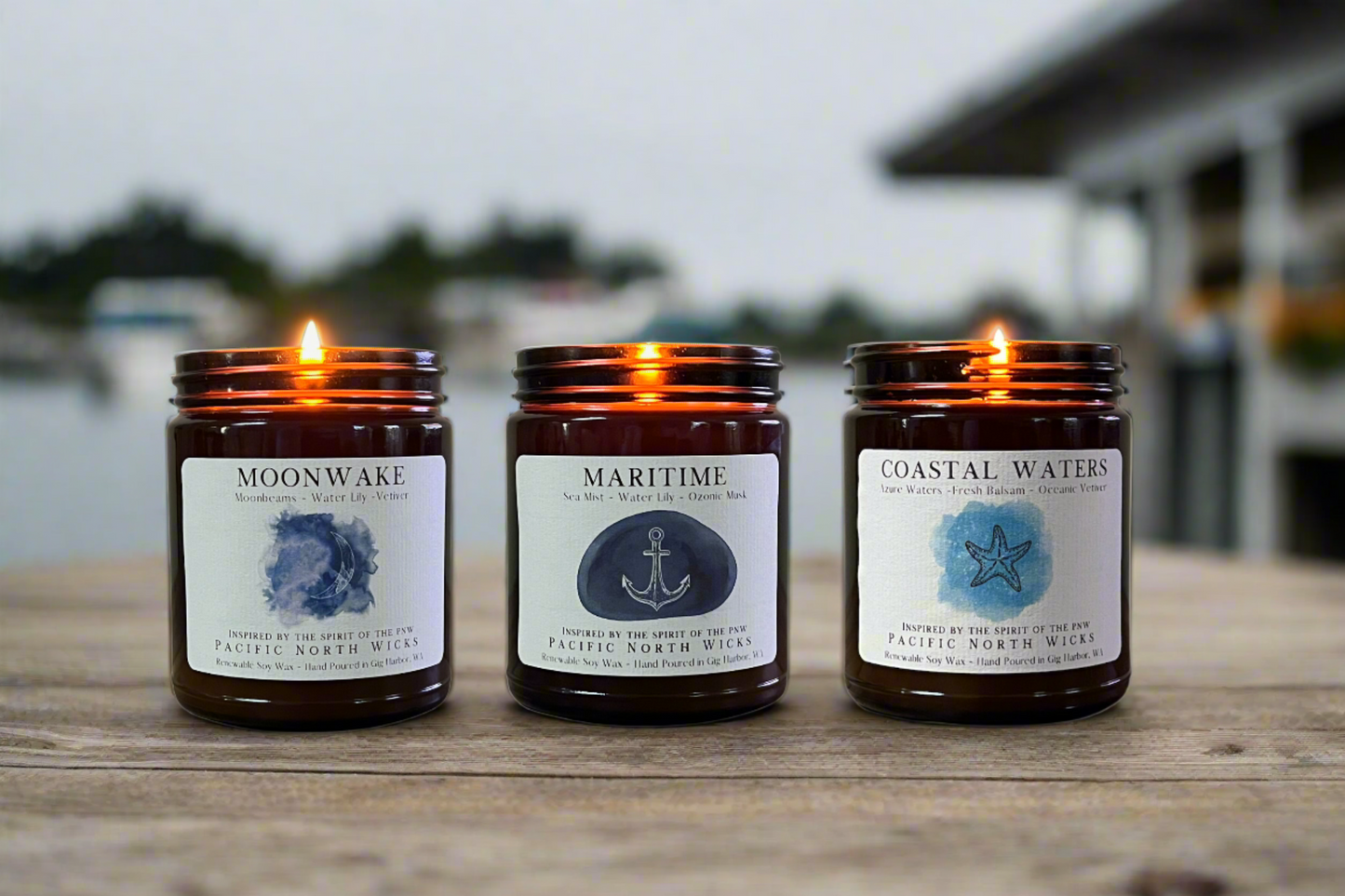 Three Marine Scented Candles set on a wooden dock in the Puget Sound.  Handmade Soy Wax candles included are Moonwake, Maritime, and Coastal Waters all inspired by the seas and waters of the Pacific Northwest.