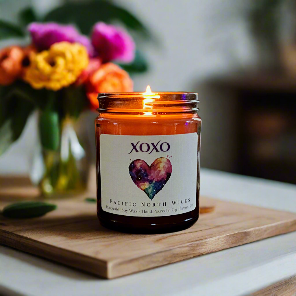 Heart Candle lit in romantic setting with colorful flowers